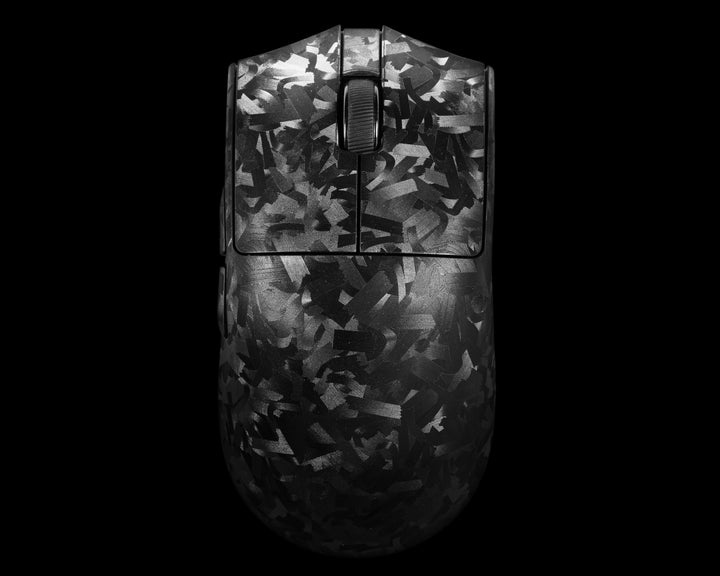 A computer mouse with a dark gray and black abstract camouflage pattern, shown from a top-down view against a solid black background.